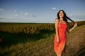 Close up of happy girl with long blonde hair running to the camera through barley field. Little smiling kid jogging over the wheat Royalty Free Stock Photo