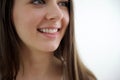 nice young woman is looking up over white background close-up happy girl's face teeth clean white even smile sincere