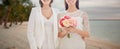 Close up of happy lesbian couple with flowers Royalty Free Stock Photo