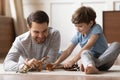 Close up happy father and adorable son playing with toys Royalty Free Stock Photo