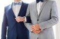 Close up of happy male gay couple holding hands Royalty Free Stock Photo