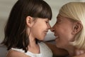 Close up happy grandmother and little granddaughter touching noses Royalty Free Stock Photo