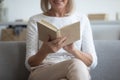 Close up of happy mature woman reading book at home Royalty Free Stock Photo