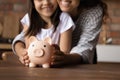 Close up happy mother and daughter holding pink piggy bank Royalty Free Stock Photo