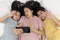 Close up happy mother and her kid making aselfie or video call to father in bed. Family concept mother and her daughter contact Royalty Free Stock Photo