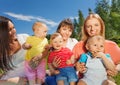 Close-up of happy mothers holding cute babies