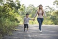 Close up of happy mum and son holding hand in a park. Royalty Free Stock Photo