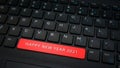 Close-up HAPPY NEW YEAR 2021 spacebar button with red color on a black laptop keyboard background. Royalty Free Stock Photo