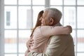 Close up happy older mature man hugging grownup daughter