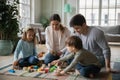 Close up happy parents and two kids playing with toys Royalty Free Stock Photo