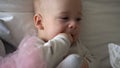 Close-up Happy playful kid 6 month old. Newborn boy looking at camera after bath shower on white soft bed. baby child Royalty Free Stock Photo