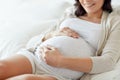 Close up of happy pregnant woman in bed at home Royalty Free Stock Photo