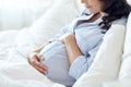 Close up of happy pregnant woman in bed at home Royalty Free Stock Photo