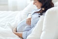 Close up of happy pregnant woman in bed at home Royalty Free Stock Photo