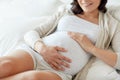 Close up of happy pregnant woman in bed at home Royalty Free Stock Photo