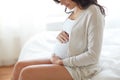 Close up of happy pregnant woman in bed at home Royalty Free Stock Photo