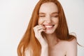 Close-up of happy redhead woman with pale no makeup skin and perfect smile, laughing and looking joyful, standing naked Royalty Free Stock Photo