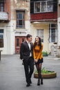 Close up of happy romantic attractive young couple smiling and hugging at the small street, old city Royalty Free Stock Photo
