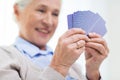 Close up of happy senior woman playing cards Royalty Free Stock Photo