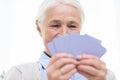 Close up of happy senior woman playing cards Royalty Free Stock Photo