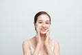 Close-up of happy smiling asian woman using daily-care skin cleansing foam and looking delighted, white background Royalty Free Stock Photo