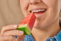 Close-up of a happy smiling Caucasian woman holding a slice of watermelon with her hand. Front three-quarter view Royalty Free Stock Photo
