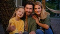 Close up happy smiling faces Caucasian family portrait outdoors in camping man father woman mother and child girl Royalty Free Stock Photo