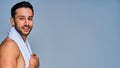 Close up happy tanned guy with black hair with a beard with a white towel on his neck. Beauty concept Royalty Free Stock Photo