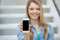 Close up of happy teenage girl showing smartphone