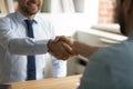 Close up happy two business men shaking hands, making agreement.