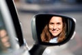 Close up happy woman driving car and looking in side mirror Royalty Free Stock Photo