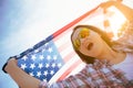 Close up happy woman holding United States of America flag Royalty Free Stock Photo