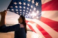 Close up happy woman holding United States of America flag Royalty Free Stock Photo