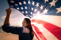 Close up happy woman holding United States of America flag Royalty Free Stock Photo