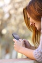 Close up of a happy woman using a smart phone Royalty Free Stock Photo