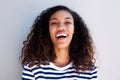 Close up happy young african american woman laughing against white wall Royalty Free Stock Photo