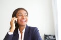 Close up happy young african businesswoman in office talking on cell phone Royalty Free Stock Photo