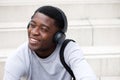 Close up happy young african man listening to music with headphones Royalty Free Stock Photo