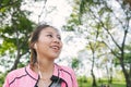 Happy young asian woman warming up her body by stretching her body before morning excercise and yoga in the park. Royalty Free Stock Photo