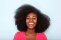 Close up happy young black woman against blue background Royalty Free Stock Photo