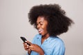 Close up happy young black woman laughing at text message on cellphone Royalty Free Stock Photo