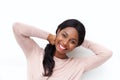 Close up happy young black woman smiling with hands behind head against white background Royalty Free Stock Photo