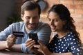Close up happy young couple making internet payment, using smartphone Royalty Free Stock Photo