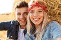 Close up of a happy young couple sitting at the wheat field Royalty Free Stock Photo