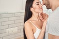 Affectionate young couple going to kiss in kitchen Royalty Free Stock Photo