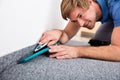 Craftsman Cutting Carpet With Cutter Royalty Free Stock Photo