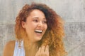 Close up happy young woman with curtly hair laughing