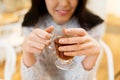 Close up of happy young woman drinking tea at cafe Royalty Free Stock Photo