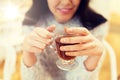 Close up of happy young woman drinking tea at cafe Royalty Free Stock Photo