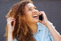 Close up happy young woman laughing and talking on mobile phone Royalty Free Stock Photo